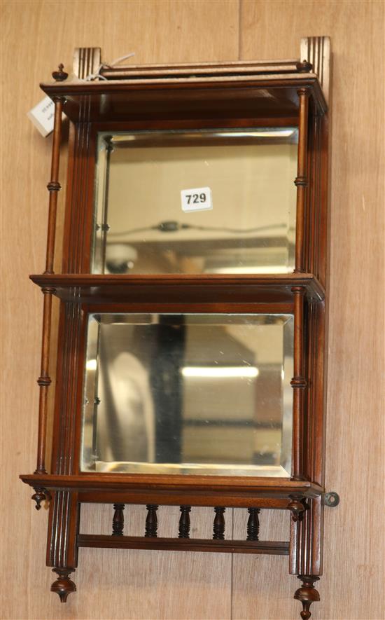 A late Victorian mahogany mirrored back three shelf wall bracket W.129cm